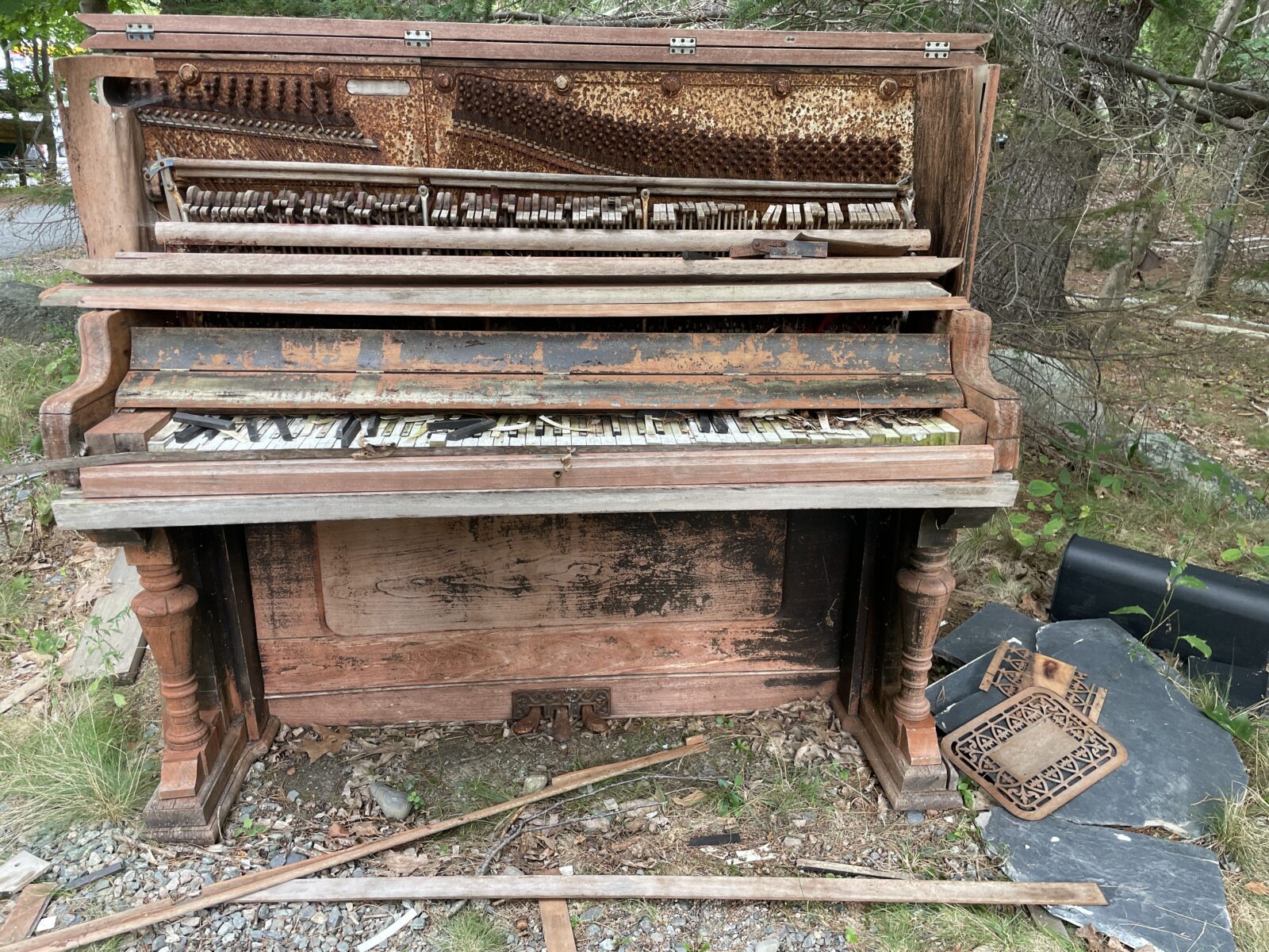 An old piano that's been sitting outdoors for years. It's no longer playable