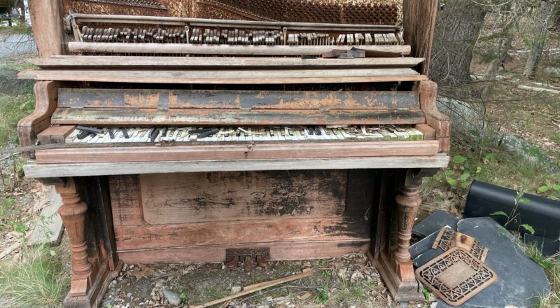 An old piano that's been sitting outdoors for years. It's no longer playable