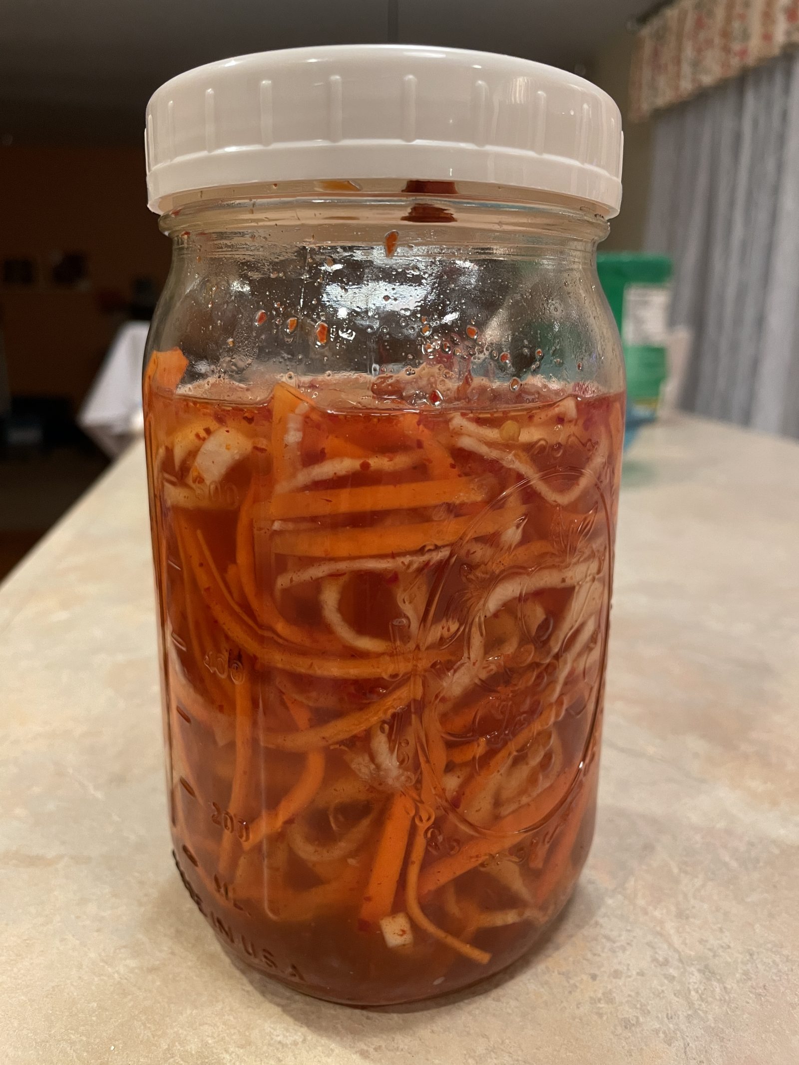 Daikon and carrot pickling in vinegar and fish sauce solution.